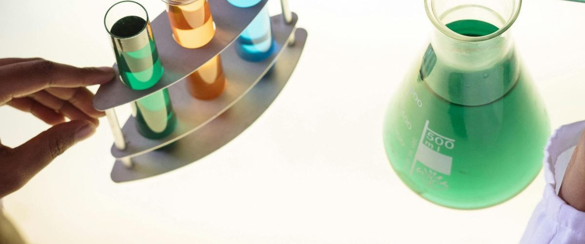 A vibrant science experiment involving colorful liquids in test tubes and a flask.